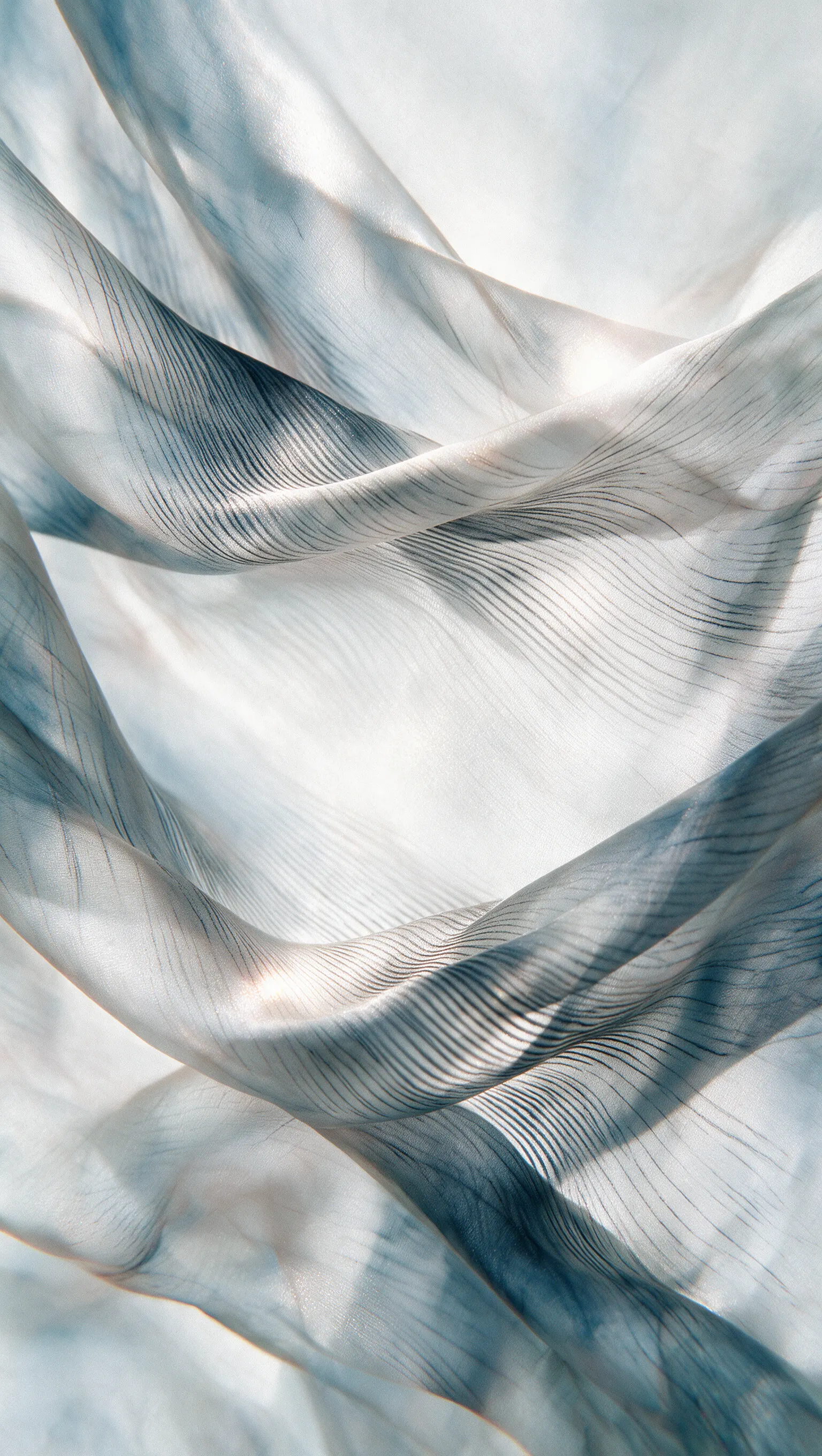Fine translucent fabric folding through soft light
